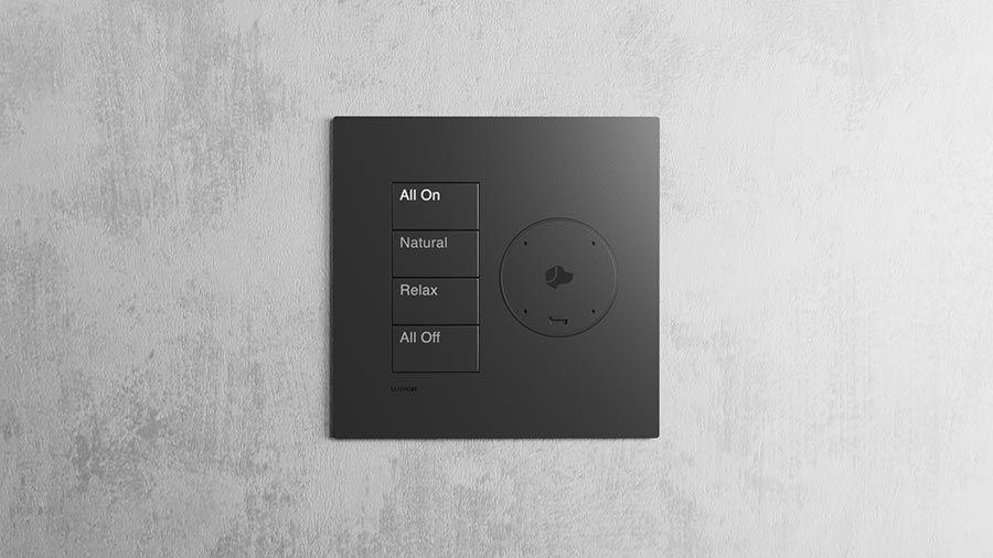 A sleek wall-mounted control panel with buttons for various lighting modes on a textured gray wall.